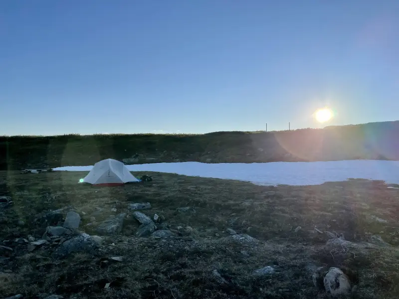 Camping spot with snowfield in the back